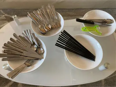 a white tray with silver utensils on a table at \u56db\u8c37\u677e\u672c\u9928\u30d3\u30eb in Tokyo