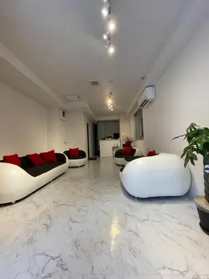 a living room with two white couches on a marble floor at HotelHarmony\u65e5\u66ae\u91cc\u30db\u30c6\u30eb\u30cf\u30fc\u30e2\u30cb\u30fc in Tokyo
