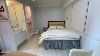 a bedroom with a bed and a sink and a bathroom at HotelHarmony\u65e5\u66ae\u91cc\u30db\u30c6\u30eb\u30cf\u30fc\u30e2\u30cb\u30fc in Tokyo