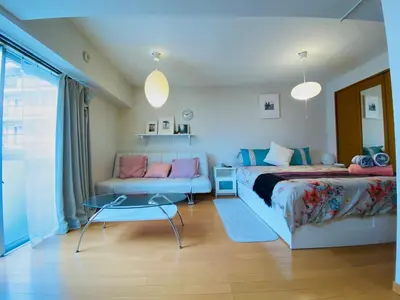 a bedroom with a bed and a couch at Suny402-SJ0007 in Tokyo