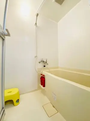 a bathroom with a bath tub and a yellow stool at Suny402-SJ0007 in Tokyo