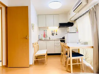 a kitchen with a table and chairs in a room at Suny402-SJ0007 in Tokyo