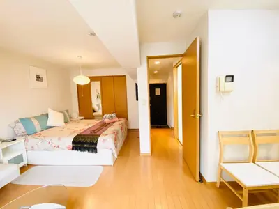 a bedroom with a bed and a chair in a room at Suny402-SJ0007 in Tokyo