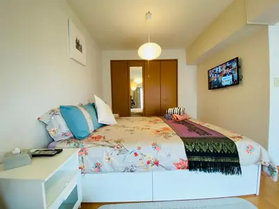 a bedroom with a large bed and a desk at Suny402-SJ0007 in Tokyo