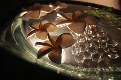a glass plate with flowers on top of it at HOTEL CHECK INN BALI adult only in Tokyo