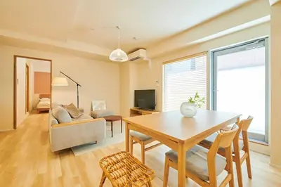 a living room with a table and a couch at \u6c5f\u6238\u5ddd\u6a4b\u30ec\u30b8\u30c7\u30f3\u30b9 EDOGAWABASHI RESIDENCE in Tokyo