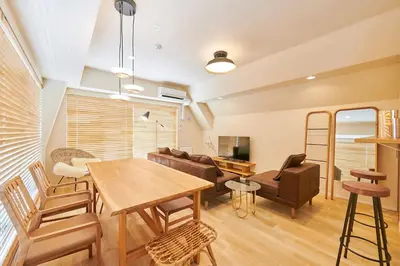 a living room with a table and a couch at \u6c5f\u6238\u5ddd\u6a4b\u30ec\u30b8\u30c7\u30f3\u30b9 EDOGAWABASHI RESIDENCE in Tokyo