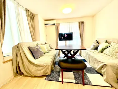 a living room with a table and a couch at \u6c5f\u6238\u5ddd\u6a4b\u30ec\u30b8\u30c7\u30f3\u30b9 EDOGAWABASHI RESIDENCE in Tokyo