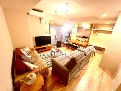 a living room with a couch and a table at \u6c5f\u6238\u5ddd\u6a4b\u30ec\u30b8\u30c7\u30f3\u30b9 EDOGAWABASHI RESIDENCE in Tokyo