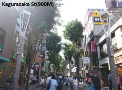 a group of people walking down a busy city street at \u6c5f\u6238\u5ddd\u6a4b\u30ec\u30b8\u30c7\u30f3\u30b9 EDOGAWABASHI RESIDENCE in Tokyo