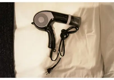 a hair dryer is hanging on a wall at Woody Sanheim - Vacation STAY 12558 in Tokyo