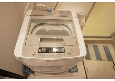 a washing machine sitting on top of a toilet at Woody Sanheim - Vacation STAY 12558 in Tokyo