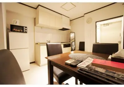 a room with a table with chairs and a kitchen at Woody Sanheim - Vacation STAY 12558 in Tokyo