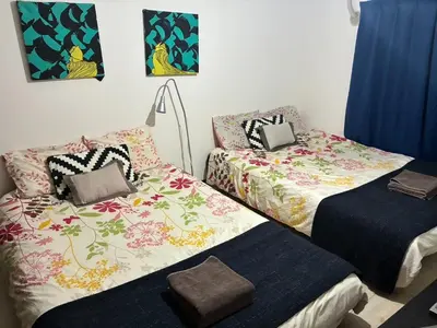 two beds sitting next to each other in a room at Woody Sanheim - Vacation STAY 12558 in Tokyo