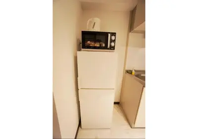 a refrigerator with a microwave on top of it at Woody Sanheim - Vacation STAY 12558 in Tokyo