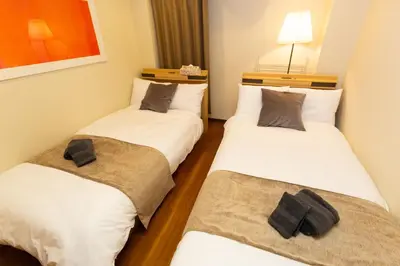 two twin beds in a room with at \u5510\u6ca2\u30db\u30c6\u30eb Karasawa-Hotel in Tokyo