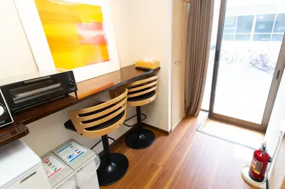 a room with two chairs and a desk with a window at \u5510\u6ca2\u30db\u30c6\u30eb Karasawa-Hotel in Tokyo
