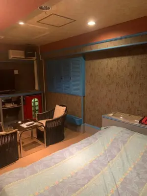 a bedroom with a bed and a table and chairs at City Hotel Dolphin in Tokyo