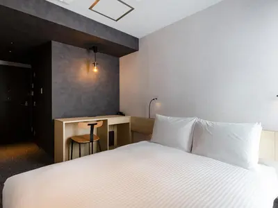 a hotel room with a bed and a desk at Akabane Holic Hotel in Tokyo