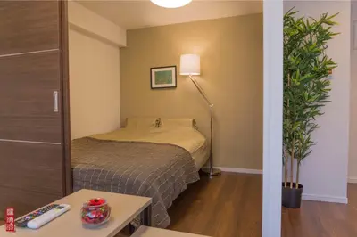 a small bedroom with a bed and a lamp at WY-Kabukicho 604-SJ0163 in Tokyo