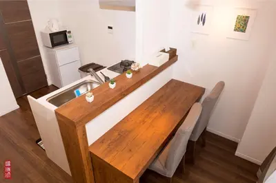 a kitchen with a wooden table and a sink at WY-Kabukicho 604-SJ0163 in Tokyo