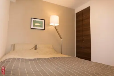 a bedroom with a bed and a floor lamp at WY-Kabukicho 604-SJ0163 in Tokyo