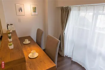 a dining room with a wooden table and a window at WY-Kabukicho 604-SJ0163 in Tokyo