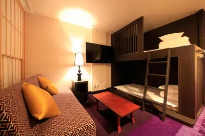 a bedroom with a bunk bed with a ladder at Centurion Hotel Ueno in Tokyo