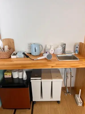 a wooden counter top with a sink and a counter top at Upper Hotel Ishihara in Tokyo