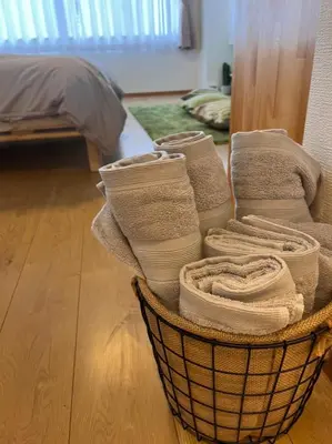 a basket filled with towels on a wooden floor at Upper Hotel Ishihara in Tokyo
