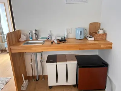 a kitchen counter with a sink and a trash can at Upper Hotel Ishihara in Tokyo