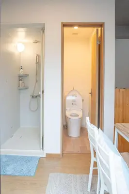 a bathroom with a toilet and a walk in shower at Upper Hotel Ishihara in Tokyo