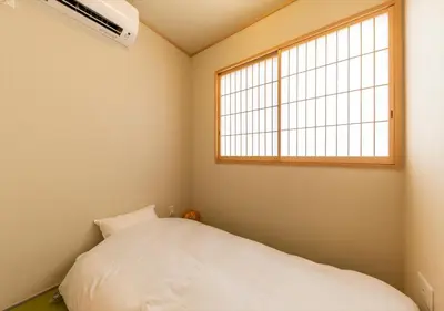 a bedroom with a white bed and a window at YADOYA Yumeji in Tokyo