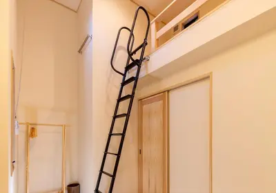 a ladder in a room next to a door at YADOYA Iroha in Tokyo