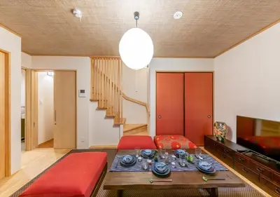 a living room with a red couch and a table at YADOYA Yanagitori East in Tokyo