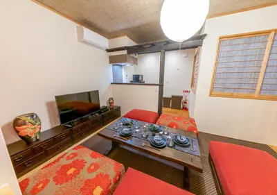 a living room with a couch and a table at YADOYA Yanagitori East in Tokyo