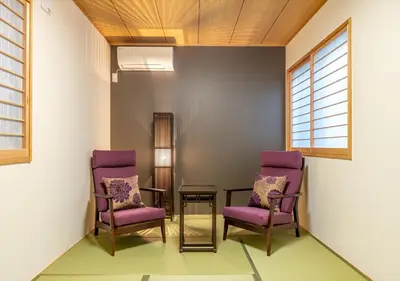 two purple chairs and a table in a room at YADOYA Yanagitori East in Tokyo