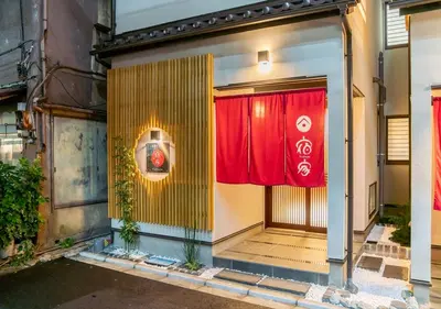 an entrance to a building with a red curtain at YADOYA Yanagitori East in Tokyo