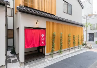 a building with a red banner on the side of it at YADOYA Yanagitori West in Tokyo