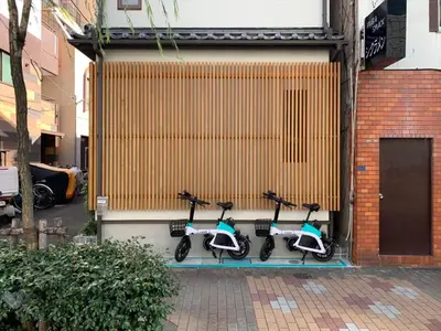 a group of scooters parked next to a building at YADOYA Yanagitori West in Tokyo