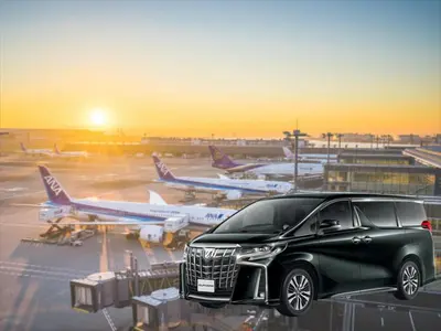 a black suv parked at an airport with planes at YADOYA Yanagitori West in Tokyo