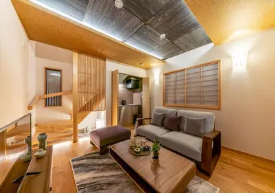 a living room with a couch and a table at YADOYA Yanagitori West in Tokyo