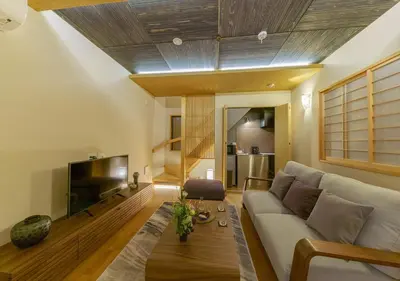 a living room with a couch and a tv at YADOYA Yanagitori West in Tokyo