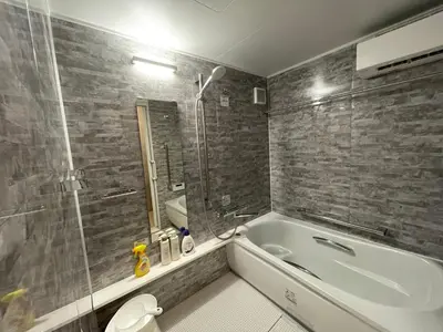 a bathroom with a bath tub and a toilet at PRISM INN OGU in Tokyo