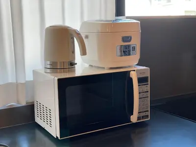 a coffee maker sitting on top of a microwave at PRISM INN OGU in Tokyo