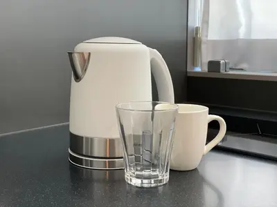 a coffee maker and a glass on a counter at PRISM INN OGU in Tokyo