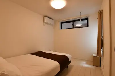 a small bedroom with a bed and a window at FL Residence Todai II in Tokyo