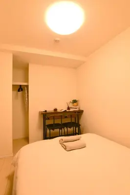 a small room with a bed and a table at FL Residence Todai II in Tokyo