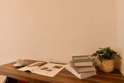 a table with books and a cup of coffee and a plant at FL Residence Todai II in Tokyo
