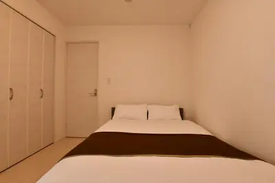 a small bedroom with a bed in it at FL Residence Todai II in Tokyo